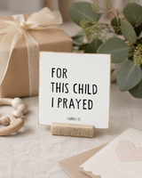 “For This Child I Prayed,” a 4 x 4-inch shelf sitter in the black lettering on white distressed finish, styled on a nursery dresser.