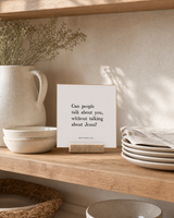 Can People Talk About You Without Talking About Jesus 4x4 Christian shelf sitter with natural wood base, styled in a cottage kitchen open shelf scene.