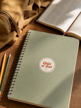 Close-up of “Child of God,” a faith sticker displayed on a school notebook.