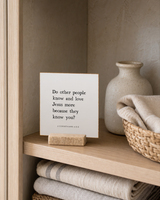 Do Other People Know and Love Jesus More 4x4 Christian shelf sitter with natural wood base, styled in a linen cabinet shelf scene.