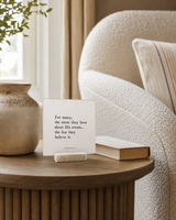 For Many, the More They Hear About His Return 4x4 Christian shelf sitter with natural wood base, styled in a reading chair side table scene.