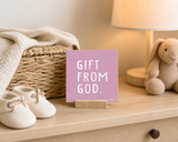Close-up of “Gift from God,” a 4 x 4-inch shelf sitter in the white text on pink finish on a newborn keepsake console.