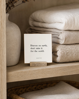 Heaven on Earth 4x4 Christian shelf sitter with natural wood base, styled in a linen cabinet shelf scene.