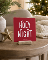 Red 4x4 Holy Night Christmas Shelf Sitter in a christmas reading nook with its rustic wood slot stand.