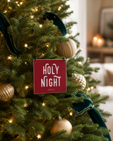 Red 4x4 Holy Night ornament with metal wire hanger on an elegant tree with star lights and deep green velvet ribbon.