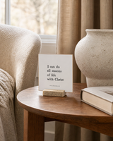 I Can Do All Seasons of Life With Christ 4x4 Christian shelf sitter with natural wood base, styled in a reading chair side table scene.