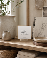 I Don't Like Humans, but I Love Them 4x4 Christian shelf sitter with natural wood base, styled in a creative studio shelf scene.