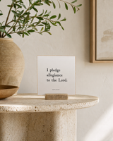 I Pledge Allegiance to the Lord 4x4 Christian shelf sitter with natural wood base, styled in a foyer pedestal table scene.