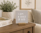 “I Am a Child of God,” a 4 x 4-inch shelf sitter in the white lettering on gray finish, styled in a family prayer corner.