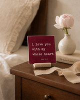 I Love You With My Whole Heart 4x4 Christian Shelf Sitter on a bedside table with a pink flower, ceramic vase, and soft neutral linens.