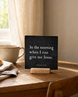 In the Morning When I Rise 4x4 Christian Shelf Sitter on a rustic table with a cream mug and folded linen beside a sunny window.