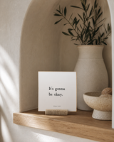 It's Gonna Be Okay 4x4 Christian shelf sitter with natural wood base, styled in a arched alcove shelf scene.