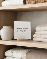 Kingdom Greatness 4x4 Christian shelf sitter with natural wood base, styled in a linen cabinet shelf scene.