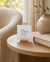 Lord, We Dedicate This Day to You 4x4 Christian shelf sitter with natural wood base, styled in a reading chair side table scene.