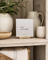 Love Your Enemy 4x4 Christian shelf sitter with natural wood base, styled in a farmhouse hutch scene.