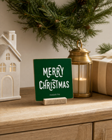 Dark Green 4x4 Merry Christmas Christmas Shelf Sitter in a christmas entry console with its rustic wood slot stand.