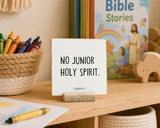 “No Junior Holy Spirit,” a 4 x 4-inch shelf sitter in the black lettering on white distressed finish, styled on a children's church shelf.