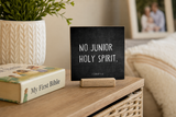 “No Junior Holy Spirit” 4 x 4-inch shelf sitter in the white lettering on black distressed finish, displayed in a family prayer corner.