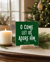 Dark Green 4x4 O Come Let Us Adore Him Christmas Shelf Sitter in a christmas church welcome table with its rustic wood slot stand.