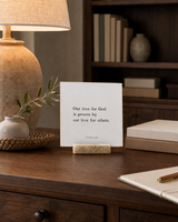 Our Love for God Is Proven by Our Love for Others 4x4 Christian shelf sitter with natural wood base, styled in a library writing desk scene.