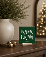 Dark Green 4x4 Pa-Rum-Pa-Pum-Pum Christmas Shelf Sitter in a elegant christmas entry console with its rustic wood slot stand.