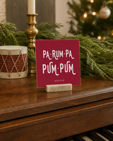 Red 4x4 Pa-Rum-Pa-Pum-Pum Christmas Shelf Sitter in a christmas music room piano with its rustic wood slot stand.