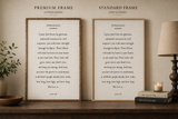 Two framed texts on a wooden shelf with a lamp and candle in the background.