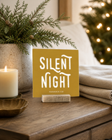 Gold 4x4 Silent Night Christmas Shelf Sitter in a christmas bedroom nightstand with its rustic wood slot stand.