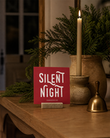 Red 4x4 Silent Night Christmas Shelf Sitter in a candlelit foyer table with its rustic wood slot stand.