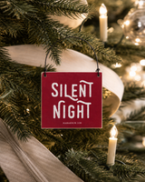 Red 4x4 Silent Night ornament with metal wire hanger on a timeless tree with clip-on candle lights and understated cream ribbon.