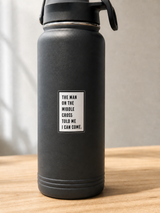 “The Man on the Middle Cross Told Me I Can Come” Christian sticker on a reusable water bottle, photographed in natural light.