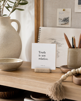 Truth Is Not Relative 4x4 Christian shelf sitter with natural wood base, styled in a creative studio shelf scene.